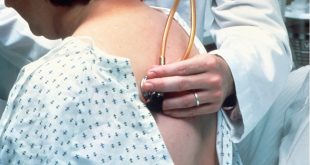 listening to patient's lungs with stethoscope