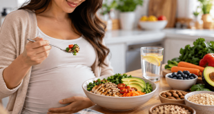Pregnant woman eating a balanced meal with whole grains, vegetables, lean protein, and other complex carbohydrate foods for gestational diabetes nutrition.